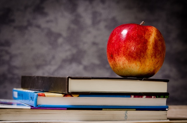 apple sitting on school books