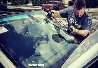 Our auto glass technician replacing the windshield on a car